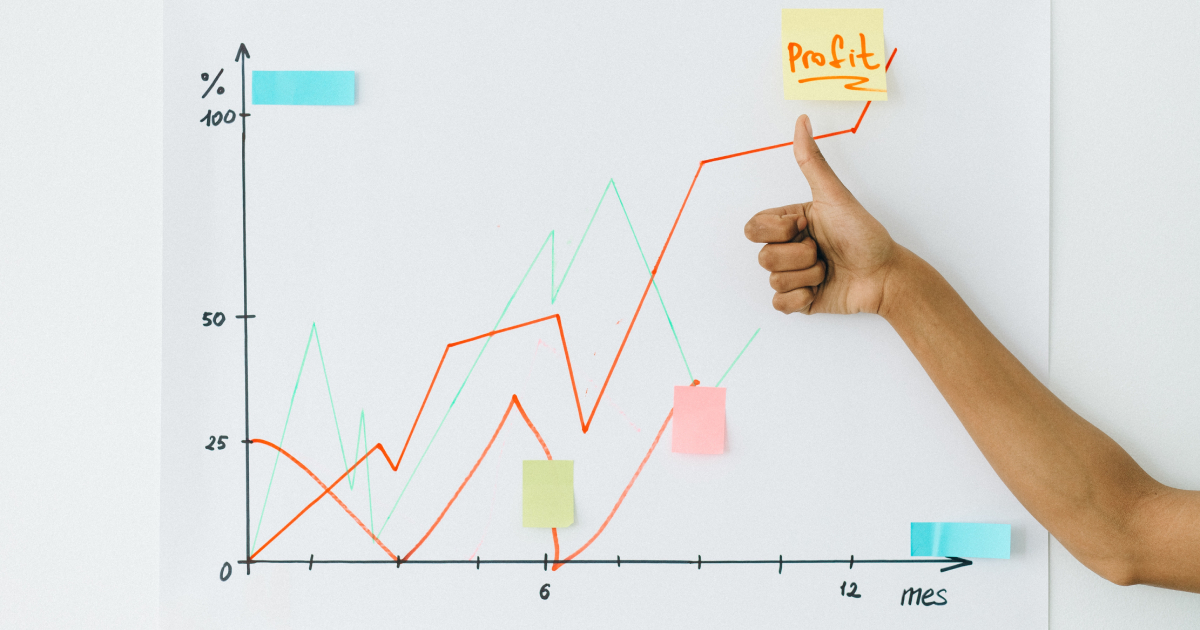 Hand in front of profit graph