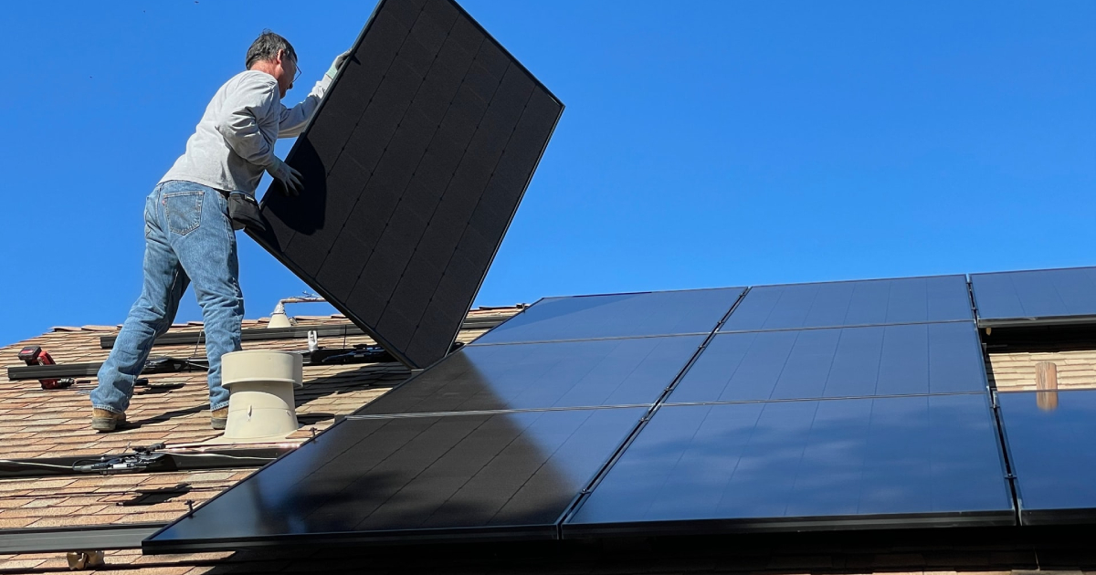 Man installing solar panels