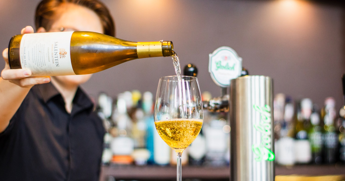 Man pouring white wine