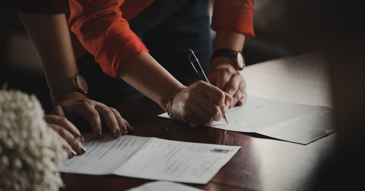 Woman signing papers