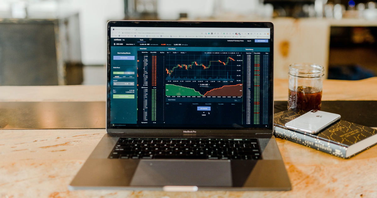 Laptop displaying investment charts