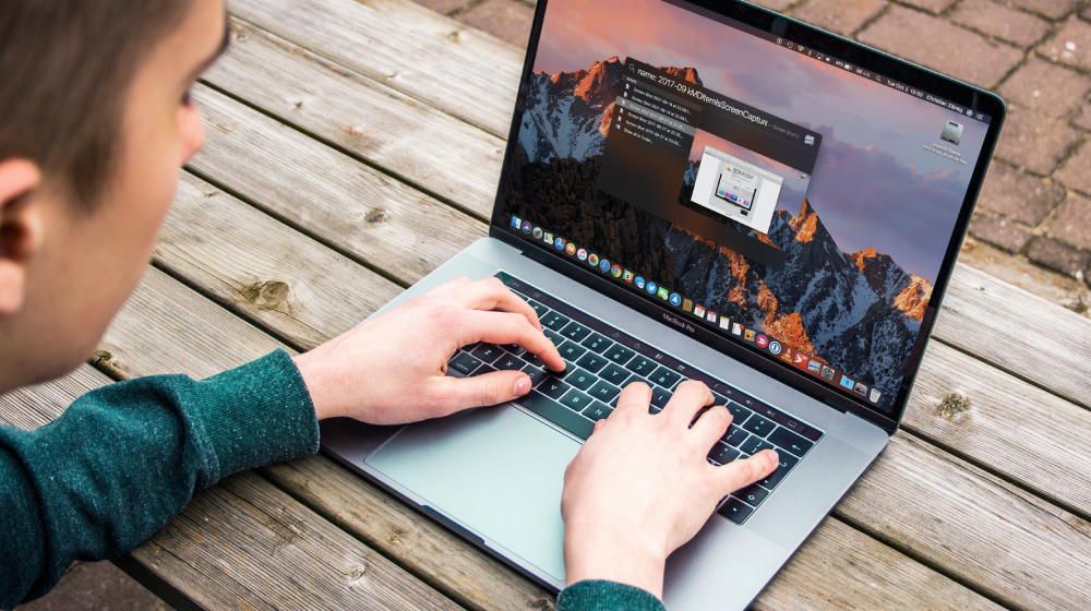 Person typing on laptop keyboard